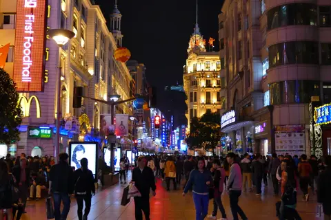 Neon-lit Nanjing Road Pedestrian Street crowded in the evening