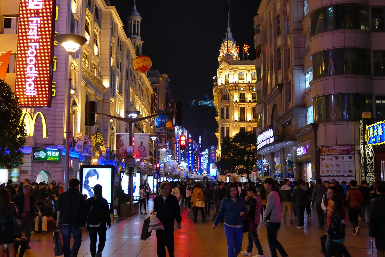 Neon-lit Nanjing Road Pedestrian Street crowded in the evening