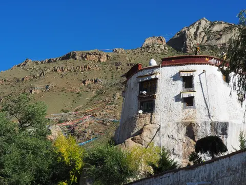 Pabonka's round whitewashed hall built atop a granite boulder