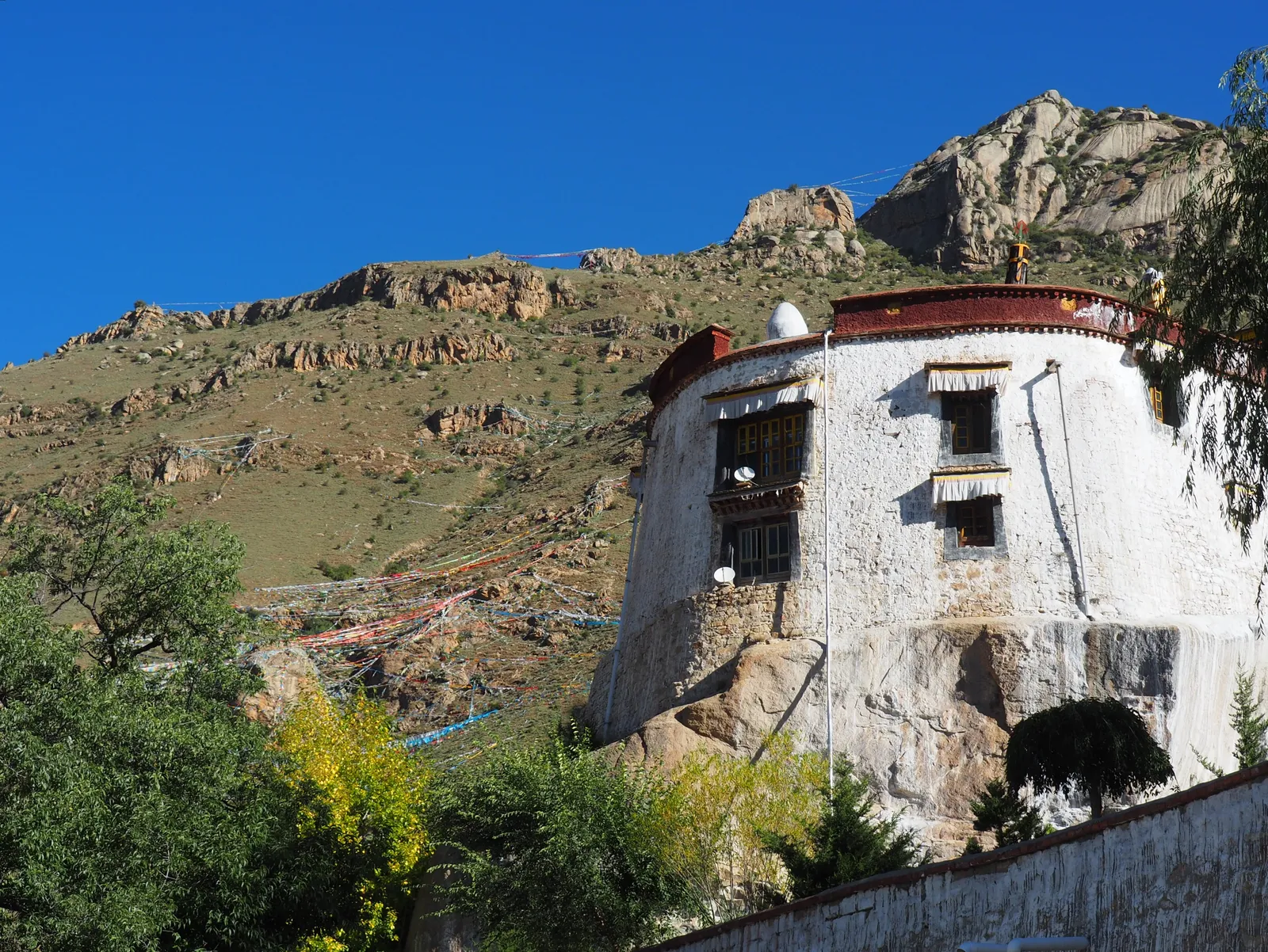 Pabonka's round whitewashed hall built atop a granite boulder