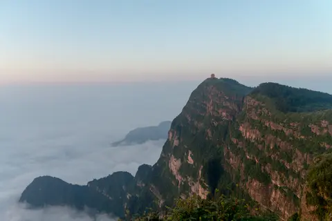 Cliffs of Mount Emei's summit rising above a sea of clouds