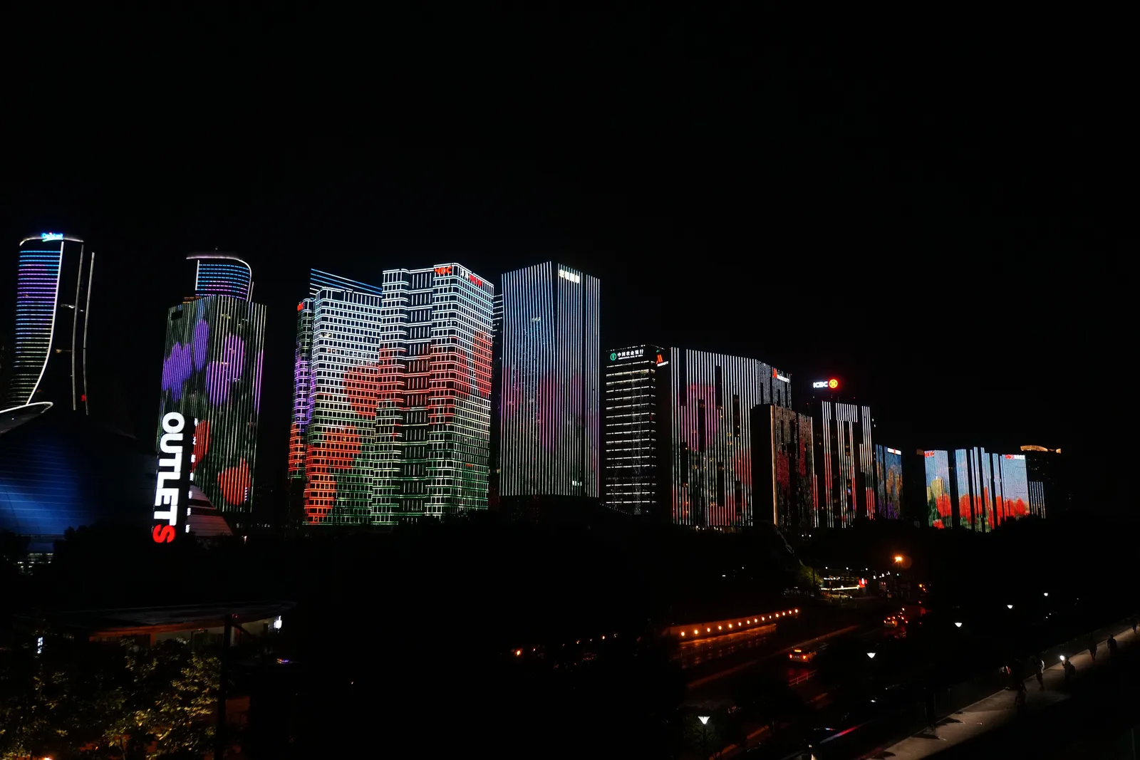 Qianjiang New City towers lit up with LED images during the night light show