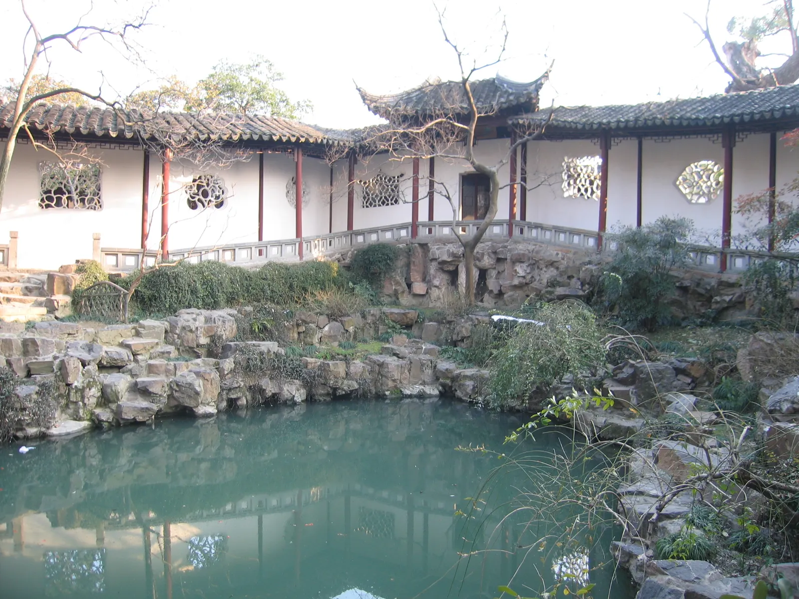Pond, rockery and white-walled corridor in Canglang Pavilion garden