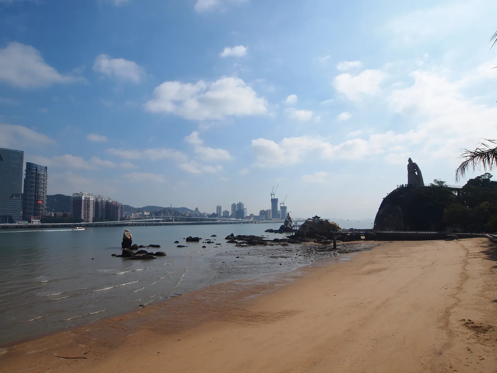 Beach at Haoyue Garden on Gulangyu with the Koxinga statue on the rocks
