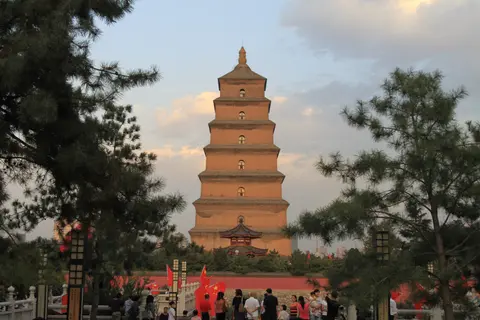 The Big Wild Goose Pagoda framed by pine trees in evening light