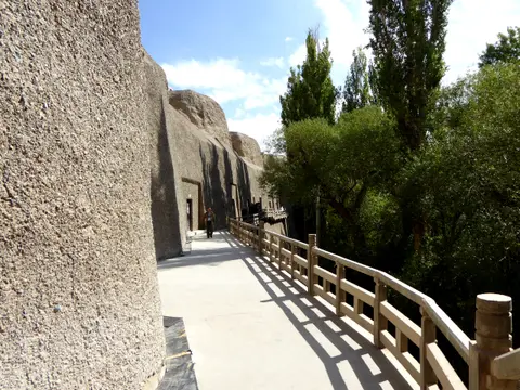 Cave-pocked cliff and walkway at the Western Thousand Buddha Caves