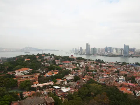 Red-roofed houses of Gulangyu with Xiamen across the strait