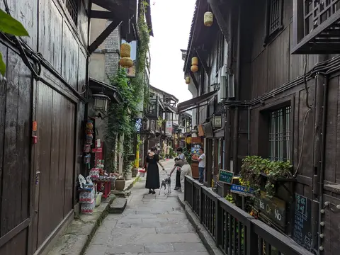 A narrow stone-paved lane lined with wooden houses in Ciqikou Old Town