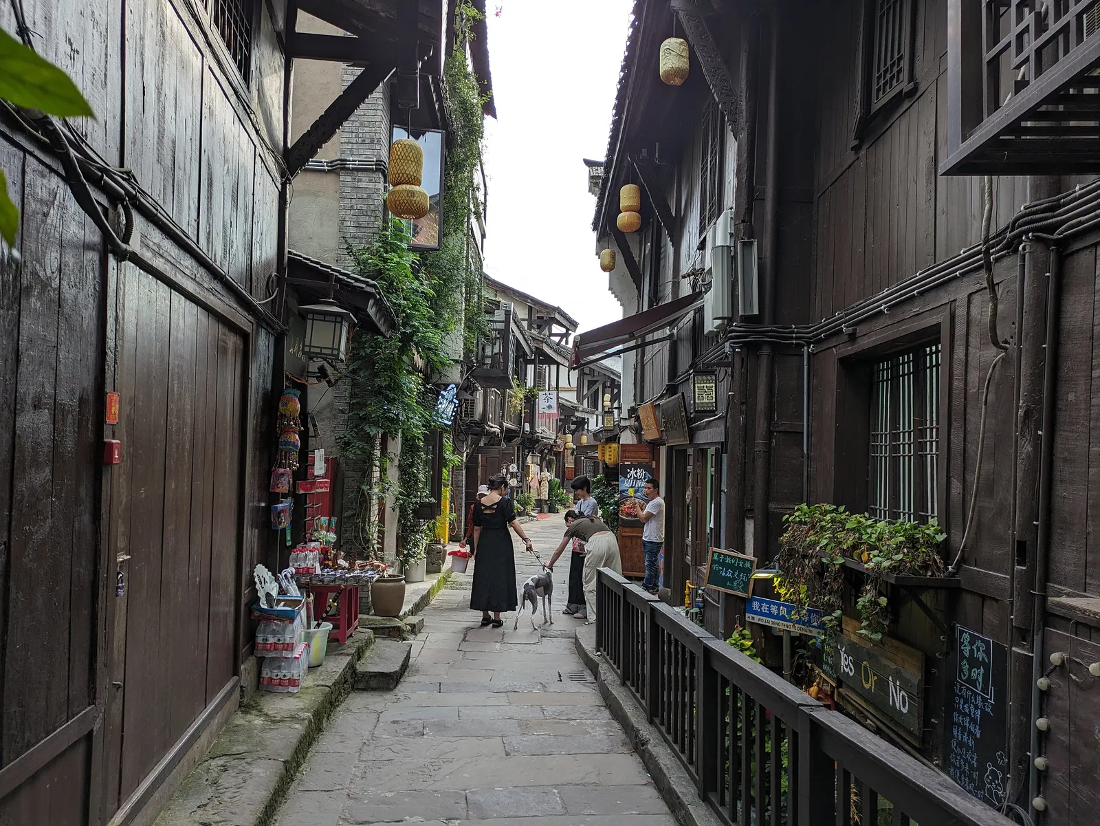 A narrow stone-paved lane lined with wooden houses in Ciqikou Old Town