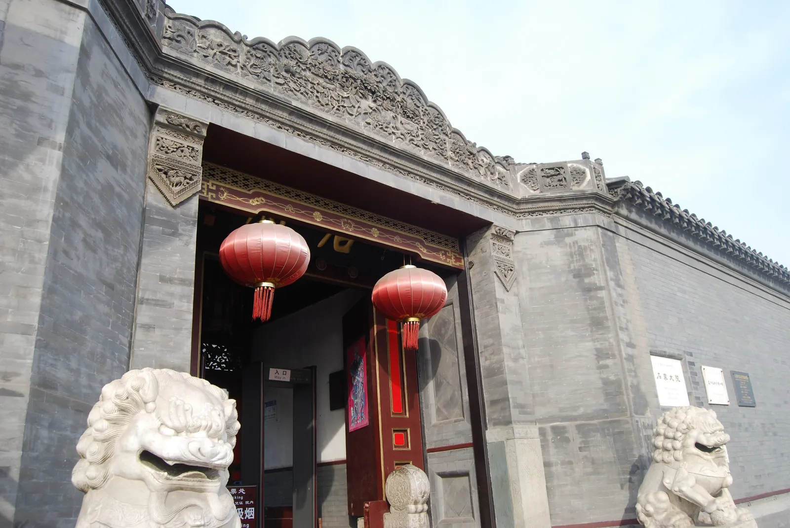 Carved brick gateway with stone lions at the Shi Family Grand Courtyard