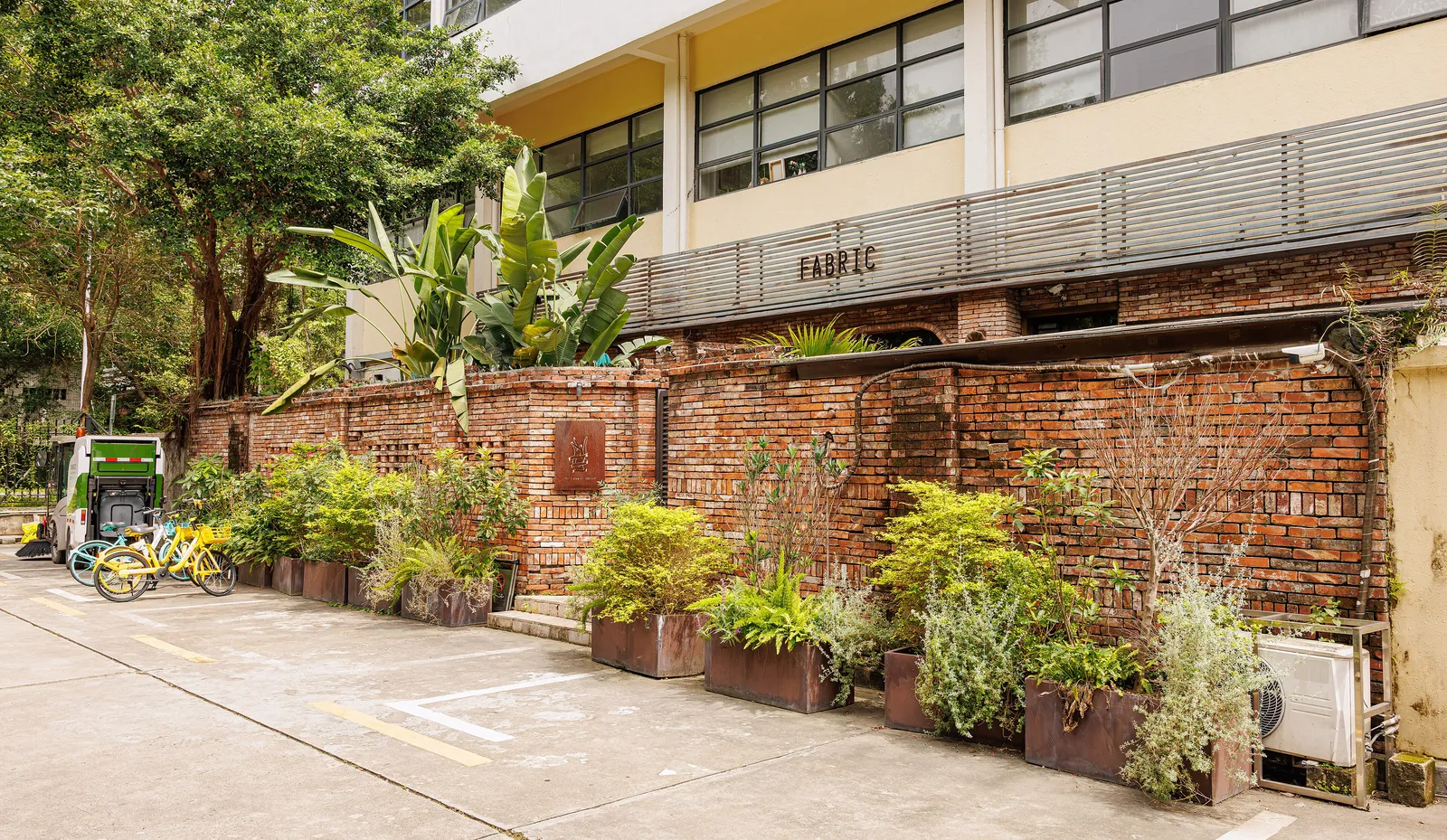 Converted factory buildings and planted brick walls at OCT Loft