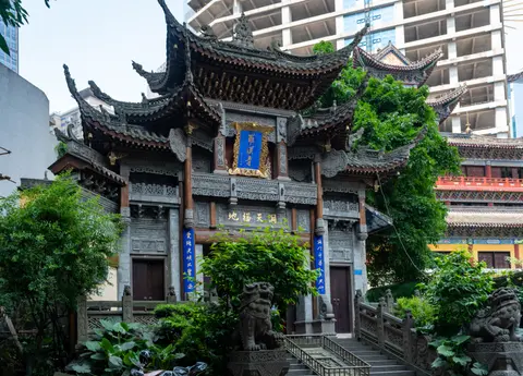 Carved gate tower of Luohan Temple among downtown Chongqing high-rises
