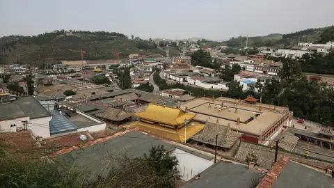 Golden roofs and halls of Kumbum Monastery spread across the hillside