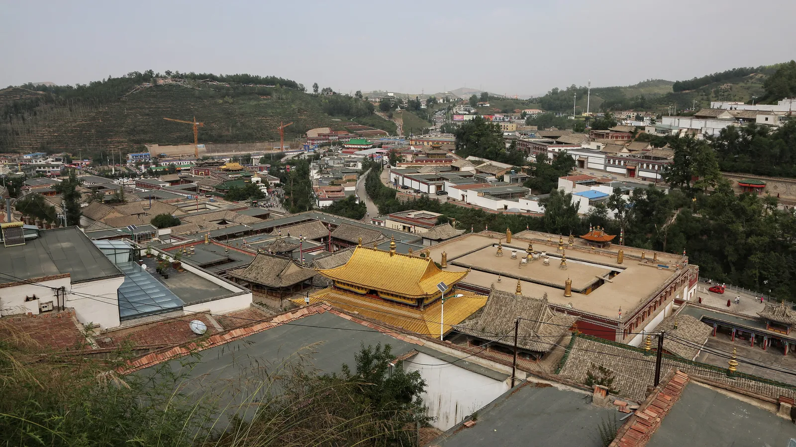 Golden roofs and halls of Kumbum Monastery spread across the hillside