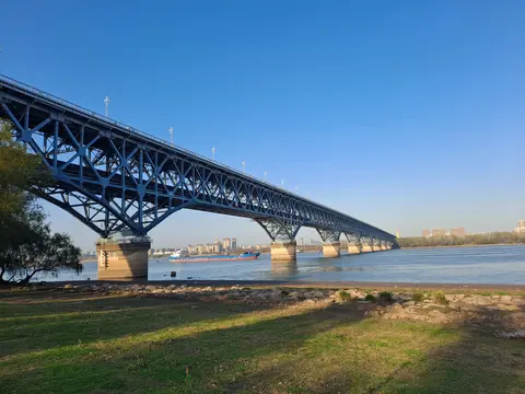 Steel truss spans of the Nanjing Yangtze River Bridge seen from the riverbank