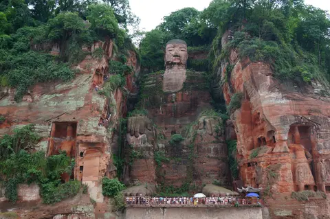 The Leshan Giant Buddha carved into the red sandstone cliff