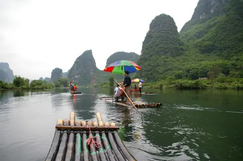 Bamboo rafts on the Yulong River among karst hills