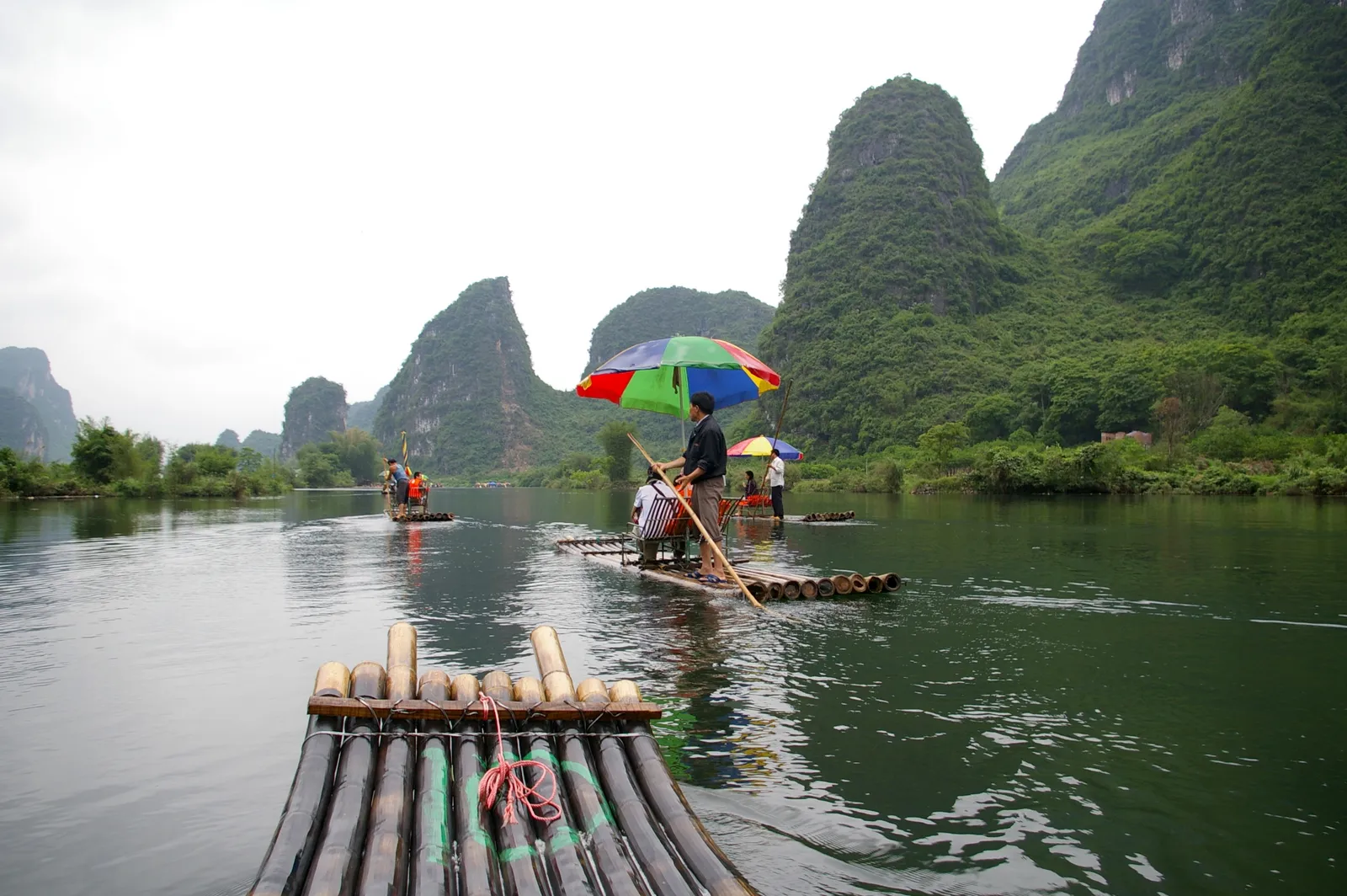 Bamboo rafts on the Yulong River among karst hills