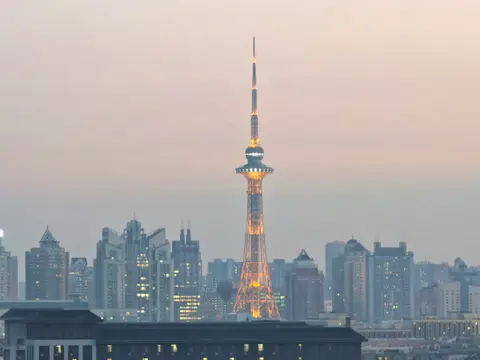 Dragon Tower rising above the Harbin skyline in evening light
