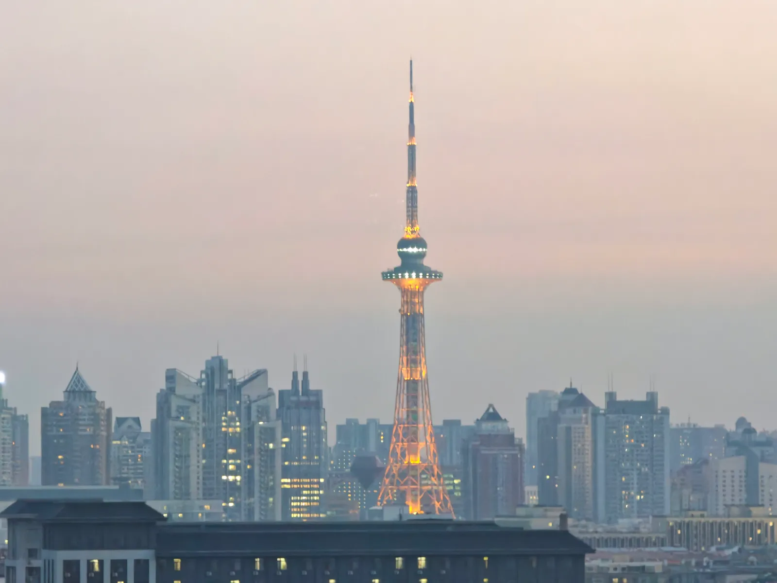 Dragon Tower rising above the Harbin skyline in evening light