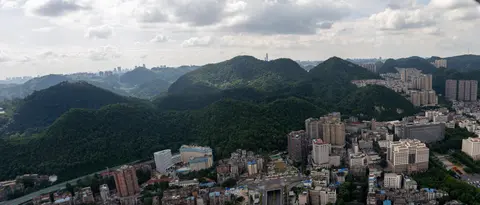 Aerial view of the forested Qianling hills rising above central Guiyang