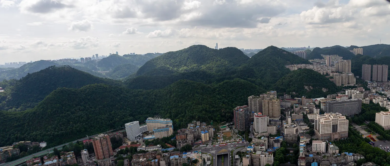 Aerial view of the forested Qianling hills rising above central Guiyang