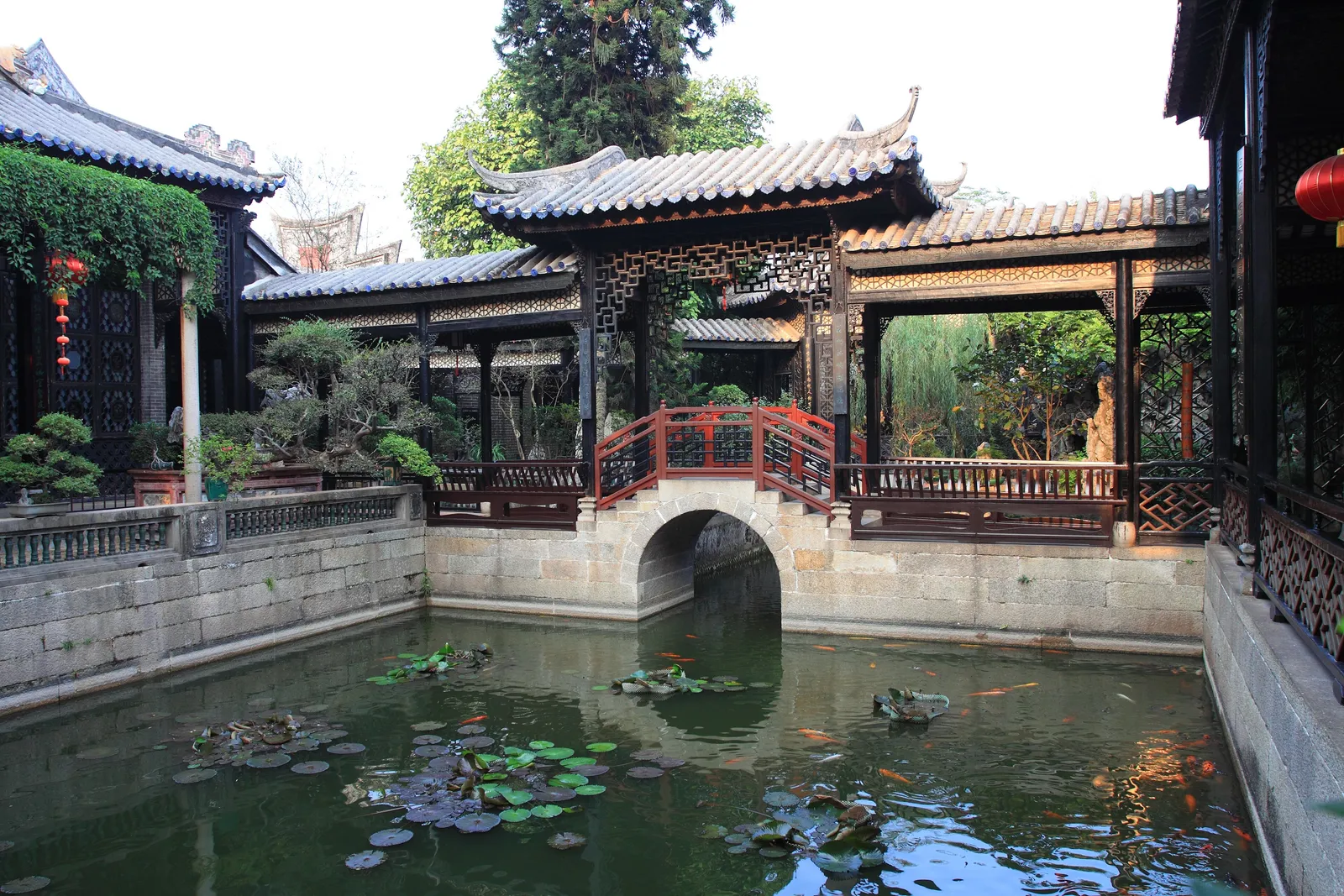 Lotus pond, arched bridge and halls in Yuyin Shanfang garden, Panyu