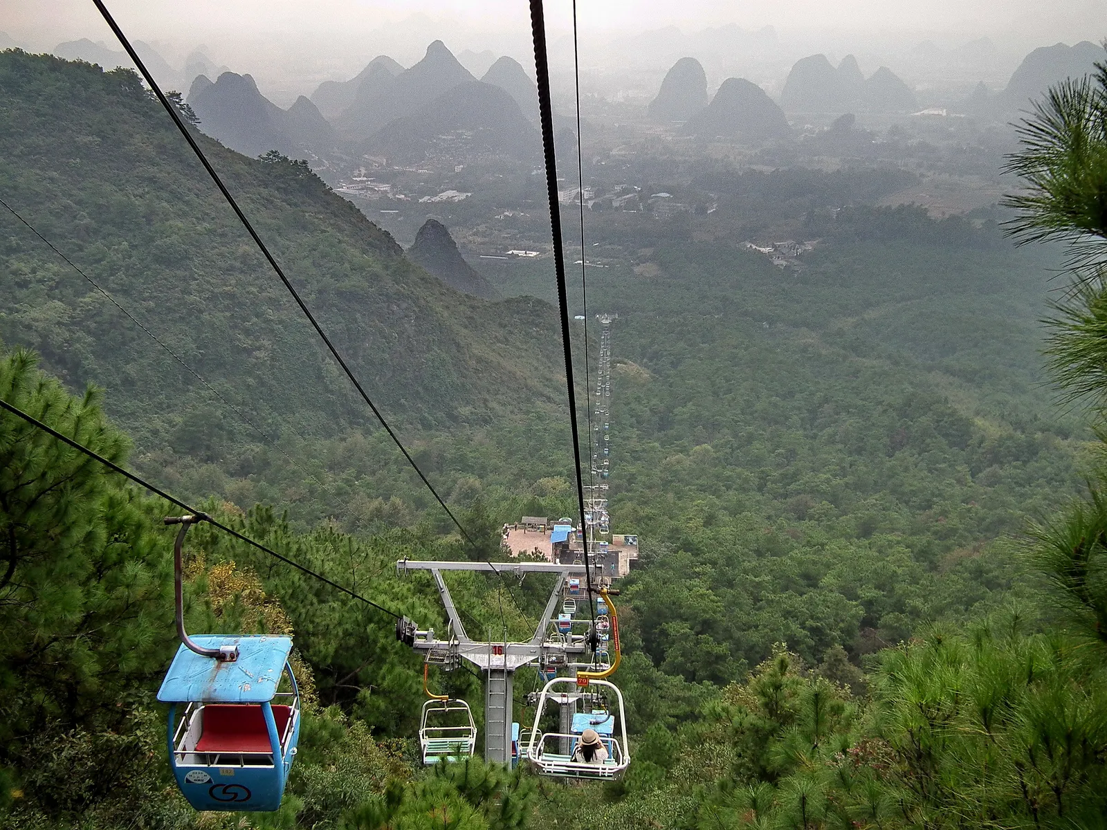 Chairlift climbing Yao Mountain with karst hills of Guilin beyond