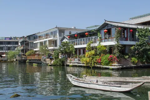 Lakeside guesthouses and moored boats at Shuanglang on Erhai Lake