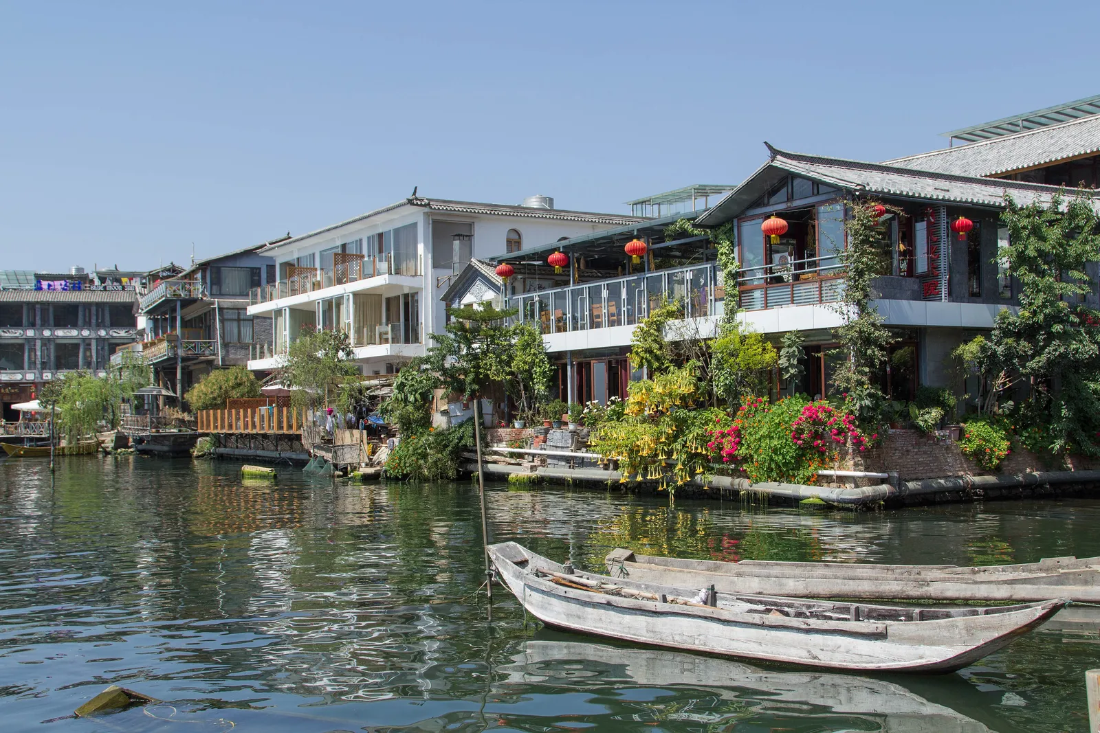 Lakeside guesthouses and moored boats at Shuanglang on Erhai Lake