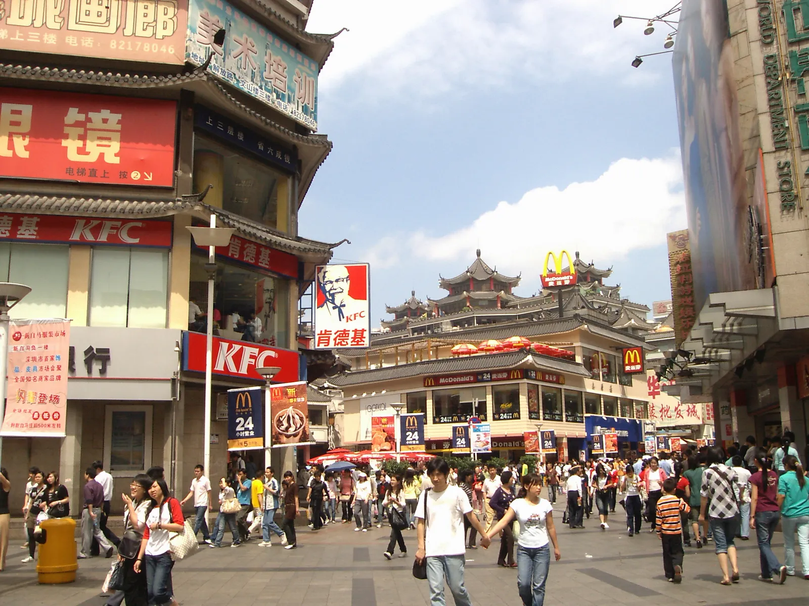 Crowds on Dongmen pedestrian street with its Chinese-style gate building