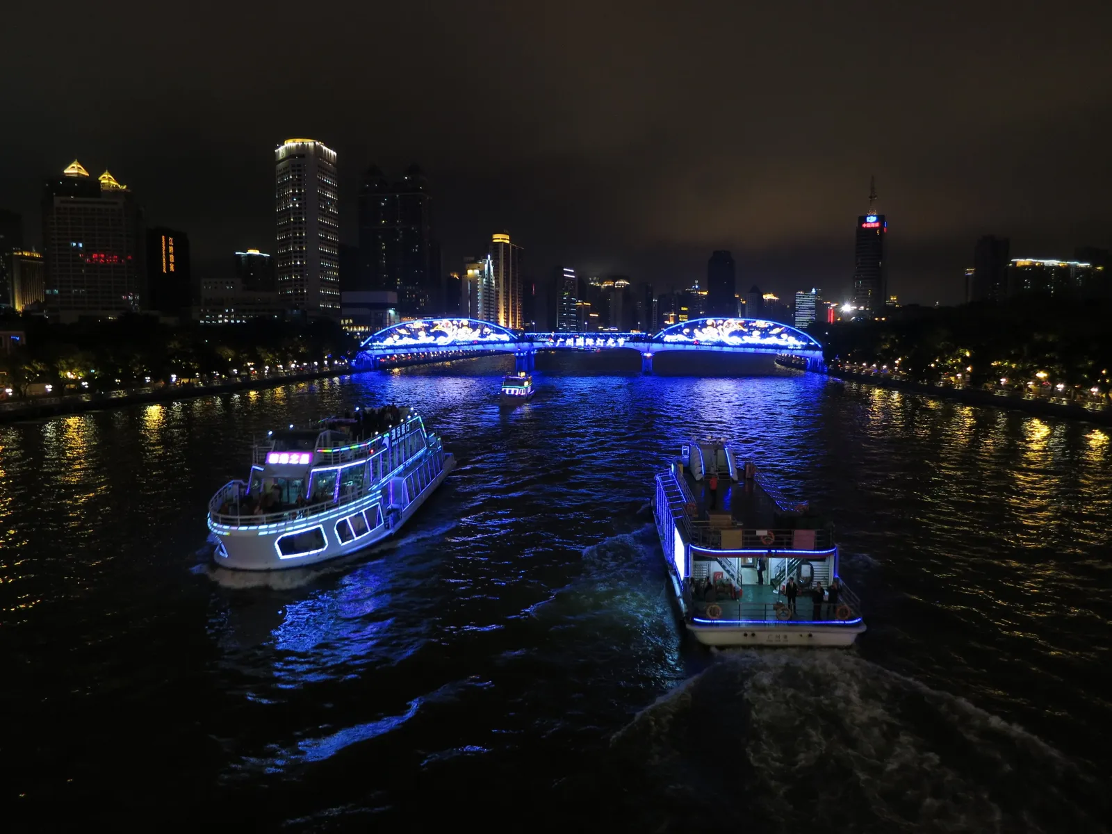 Illuminated cruise boats on the Pearl River at night in Guangzhou