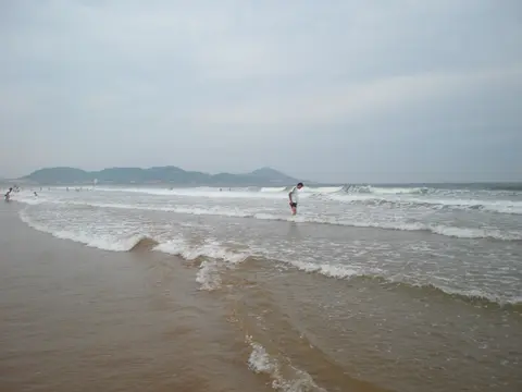 Waves washing onto the wide sands of Golden Beach in Huangdao