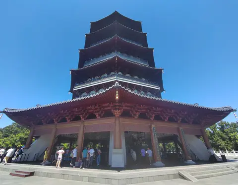 Leifeng Pagoda's tiered roofs against a blue sky