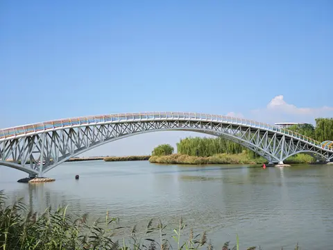 Arched footbridge over the water at Sand Lake
