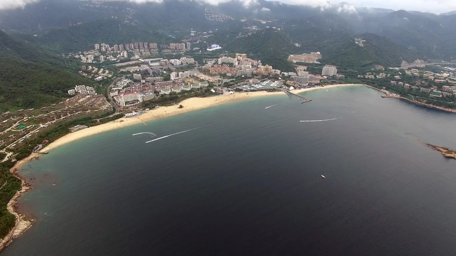Dameisha's curved sandy beach and bay seen from the sea