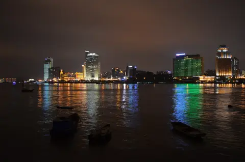 Xiamen's Lujiang waterfront lit up at night, seen across the strait from Gulangyu
