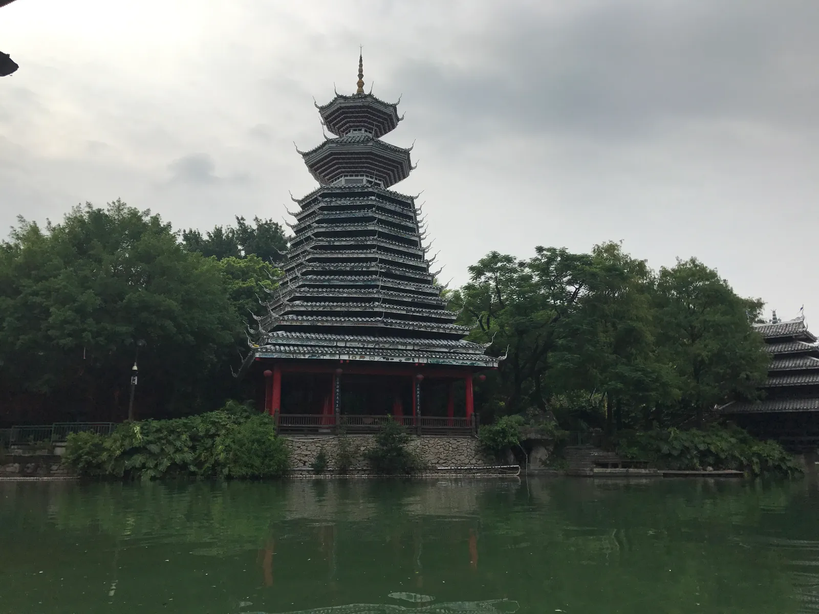 A Dong-style drum tower by the lake in the Folk Culture Village