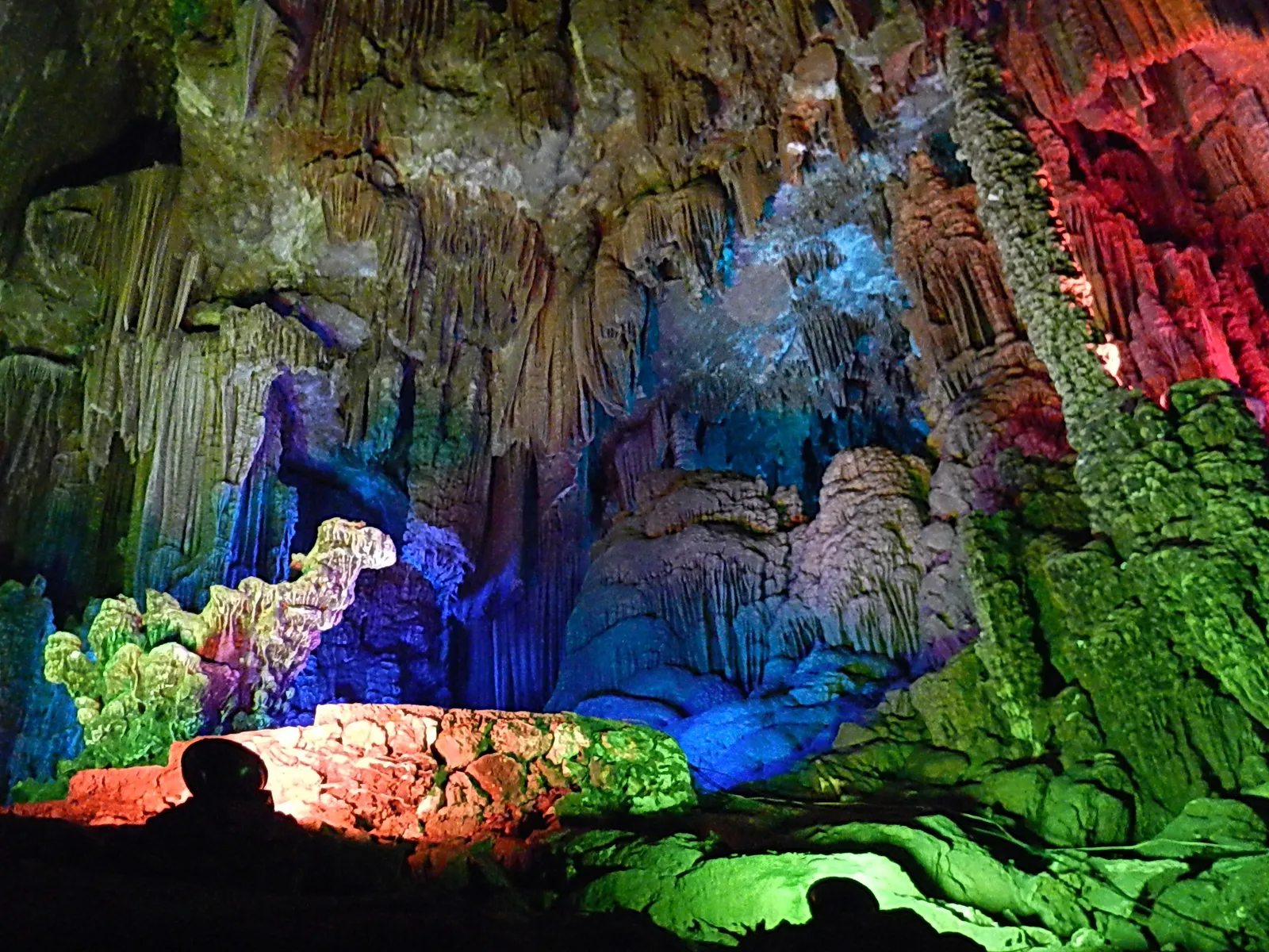 Colourfully lit stalactites and flowstone inside Silver Cave