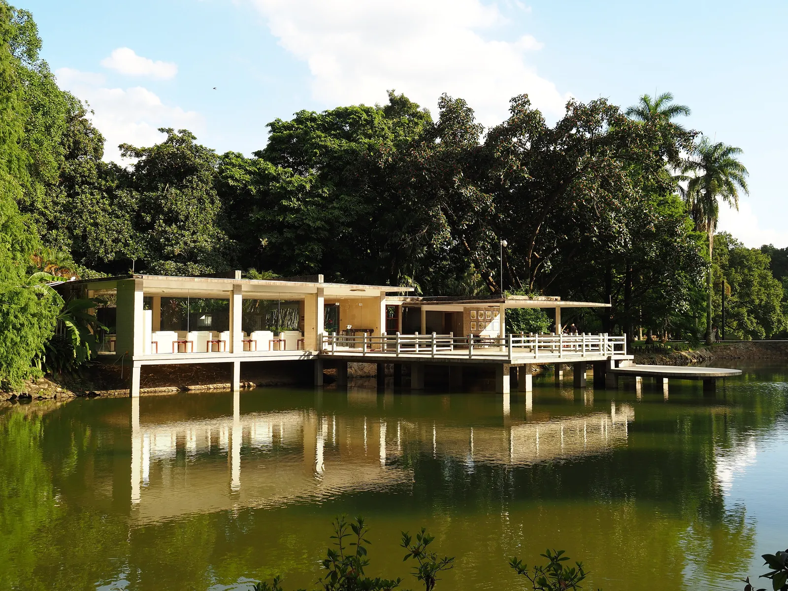 A lakeside pavilion among tropical trees in South China Botanical Garden