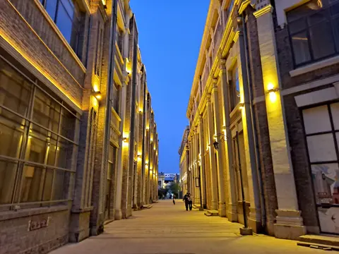 Restored Chinese Baroque facades along a lane in Old Daowai at dusk