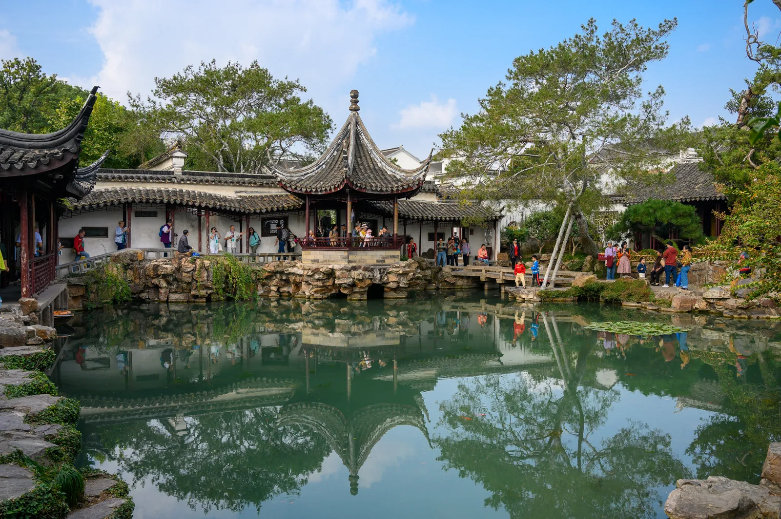 Central pond and pavilion reflected in the Master of the Nets Garden