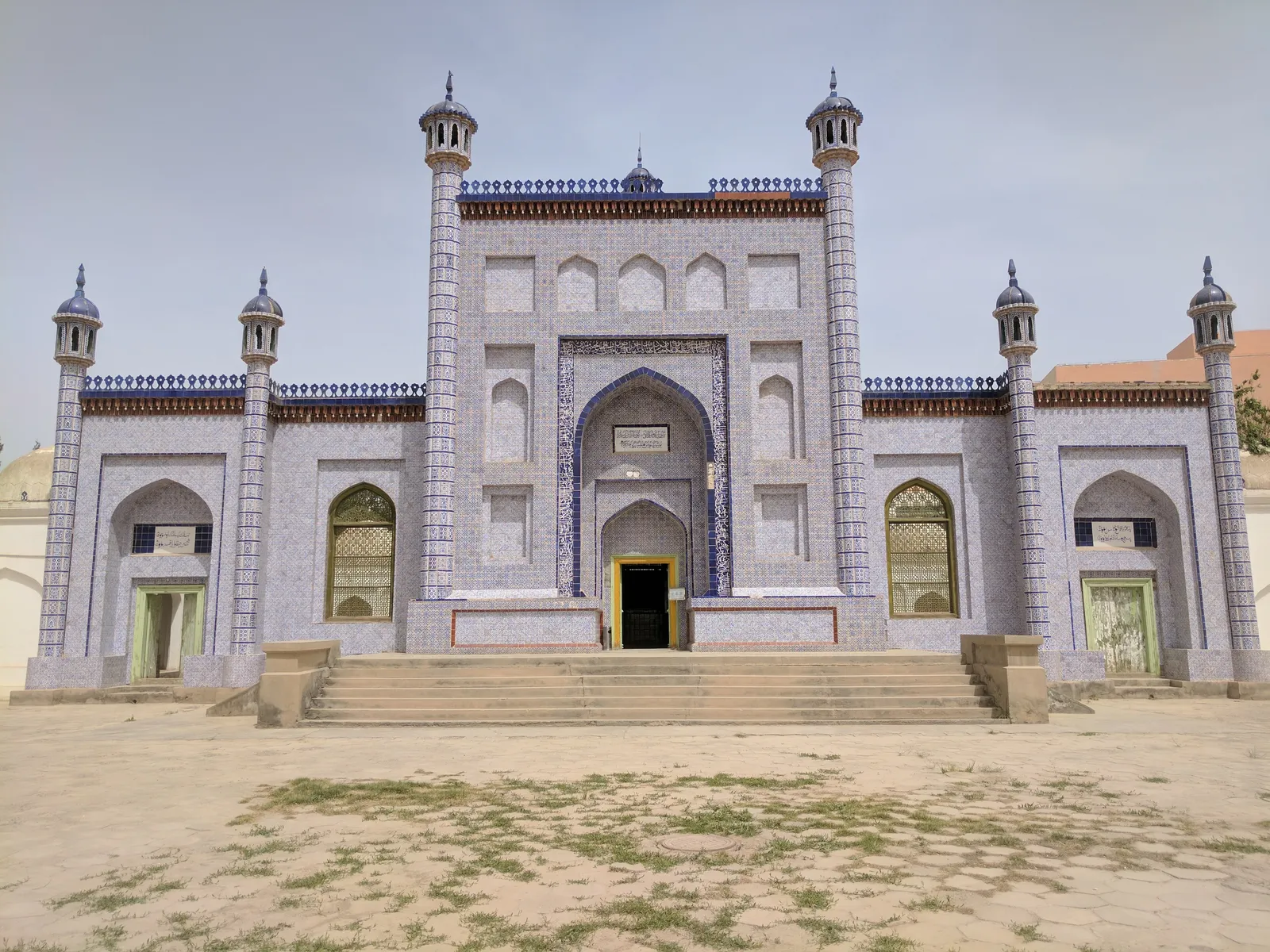 Blue-tiled facade and minarets of the Mausoleum of Yusuf Khass Hajib