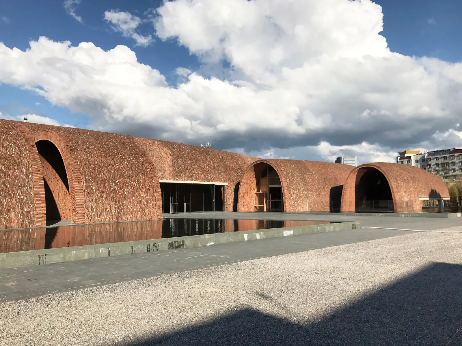 The brick-vaulted Imperial Kiln Museum beside a reflecting pool