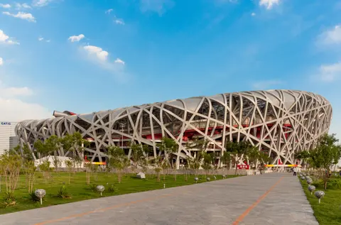 The steel lattice of the Bird’s Nest National Stadium on a sunny day