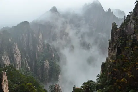 Mist rolling through the jagged peaks of the West Sea Grand Canyon