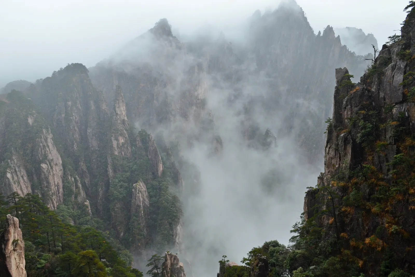 Mist rolling through the jagged peaks of the West Sea Grand Canyon