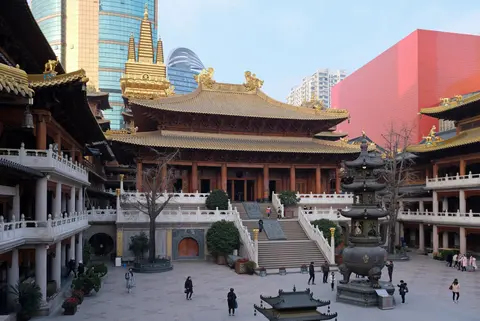 Golden-roofed halls of Jing’an Temple among Shanghai skyscrapers