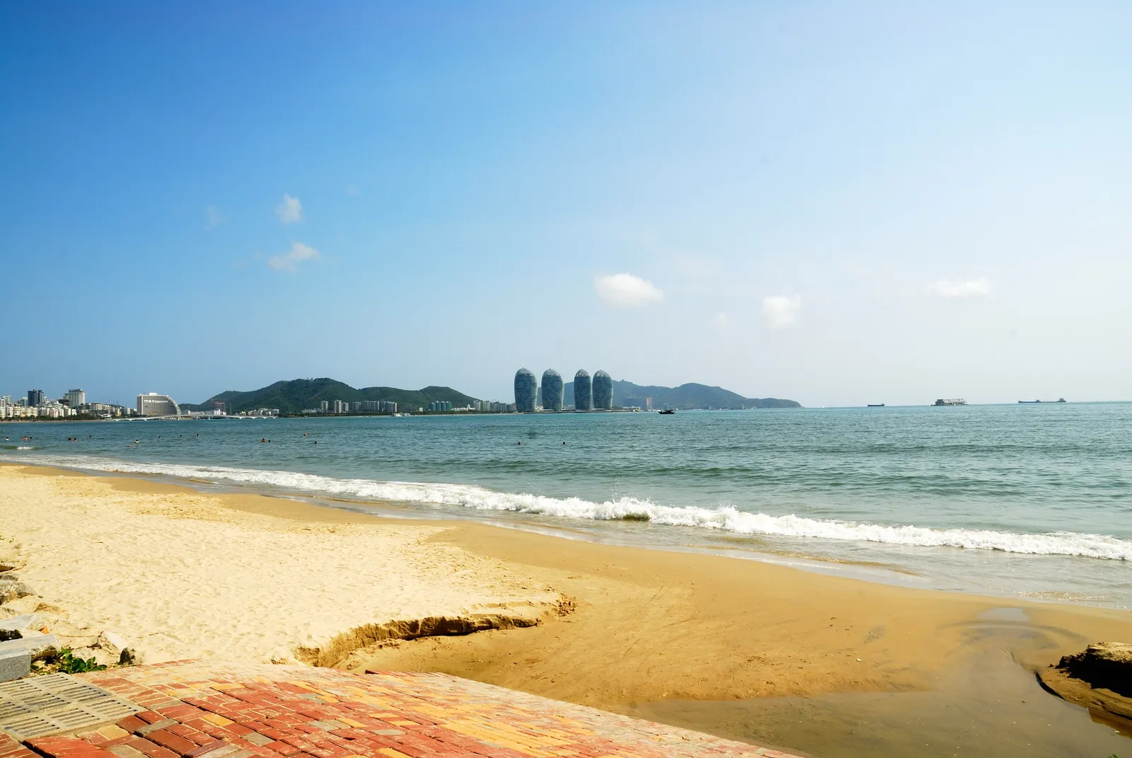 The long sandy beach of Sanya Bay with Phoenix Island offshore