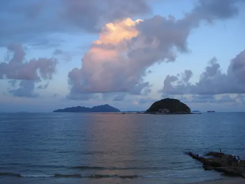 Sunset over the sea and offshore islets at Xichong Beach